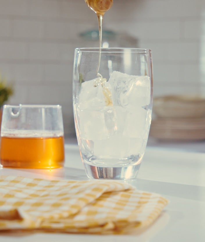 Agregar miel en un vaso con hielo y leche