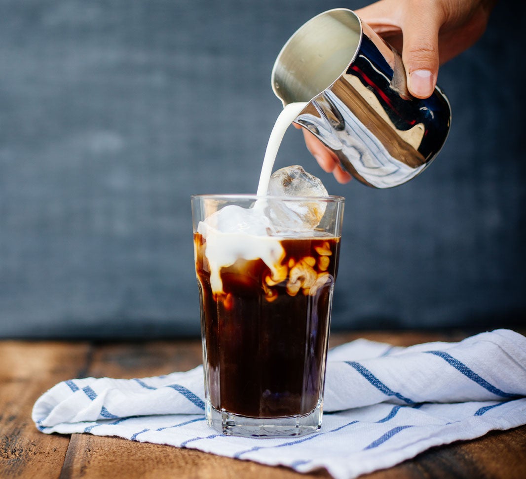 Milk pouring into an espresso drink