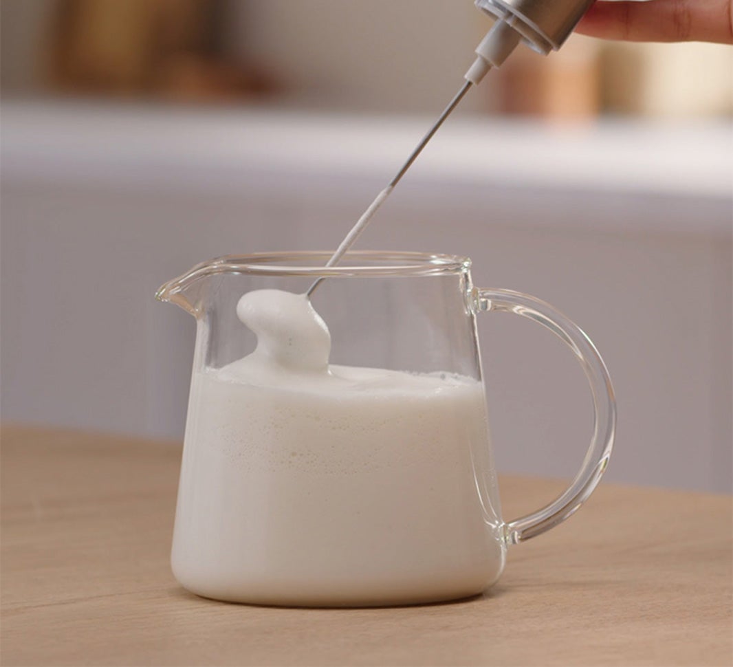 Frothing milk in a glass jug