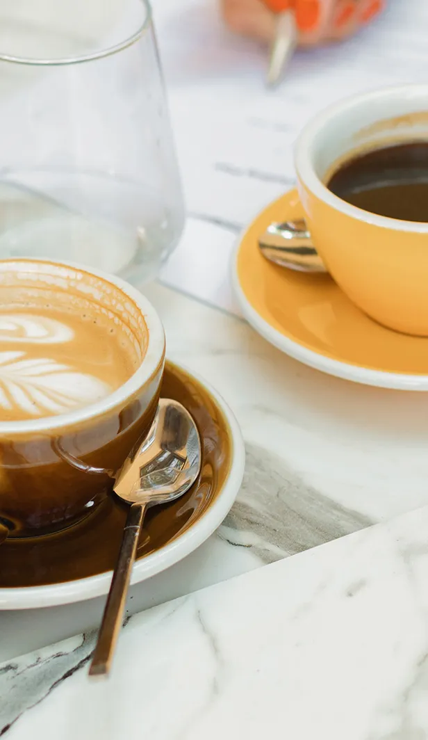 A cup of americano and a cup of flat white