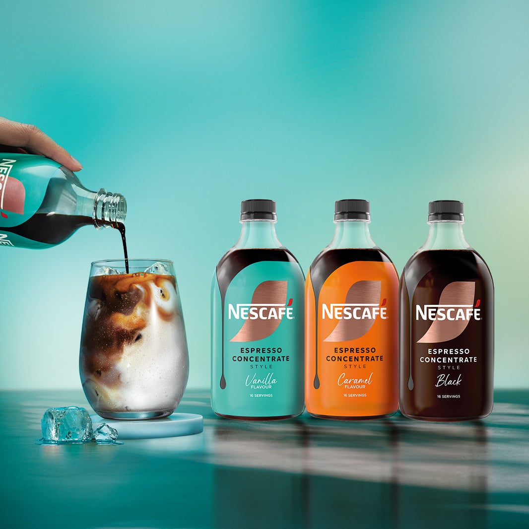 Hand pouring espresso concentrate into a glass