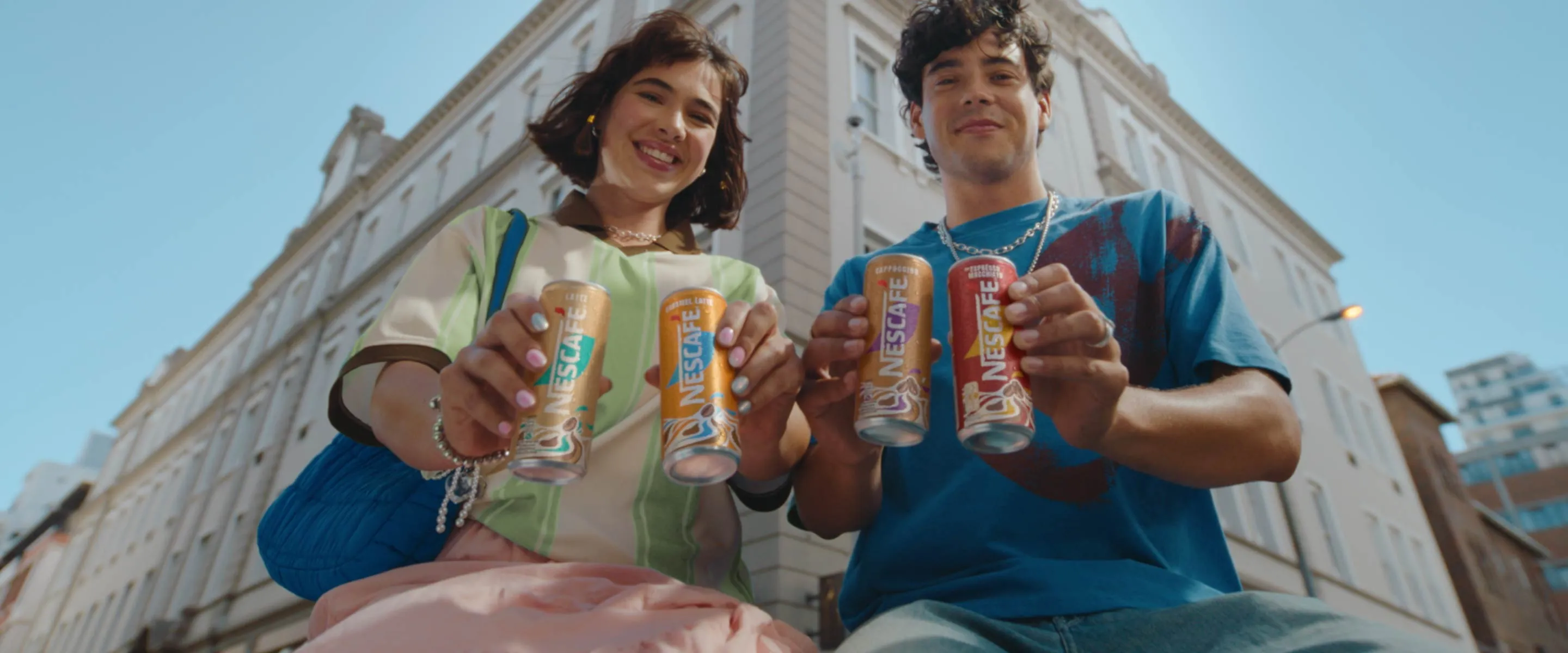young people holding nescafe ready to drink coffee