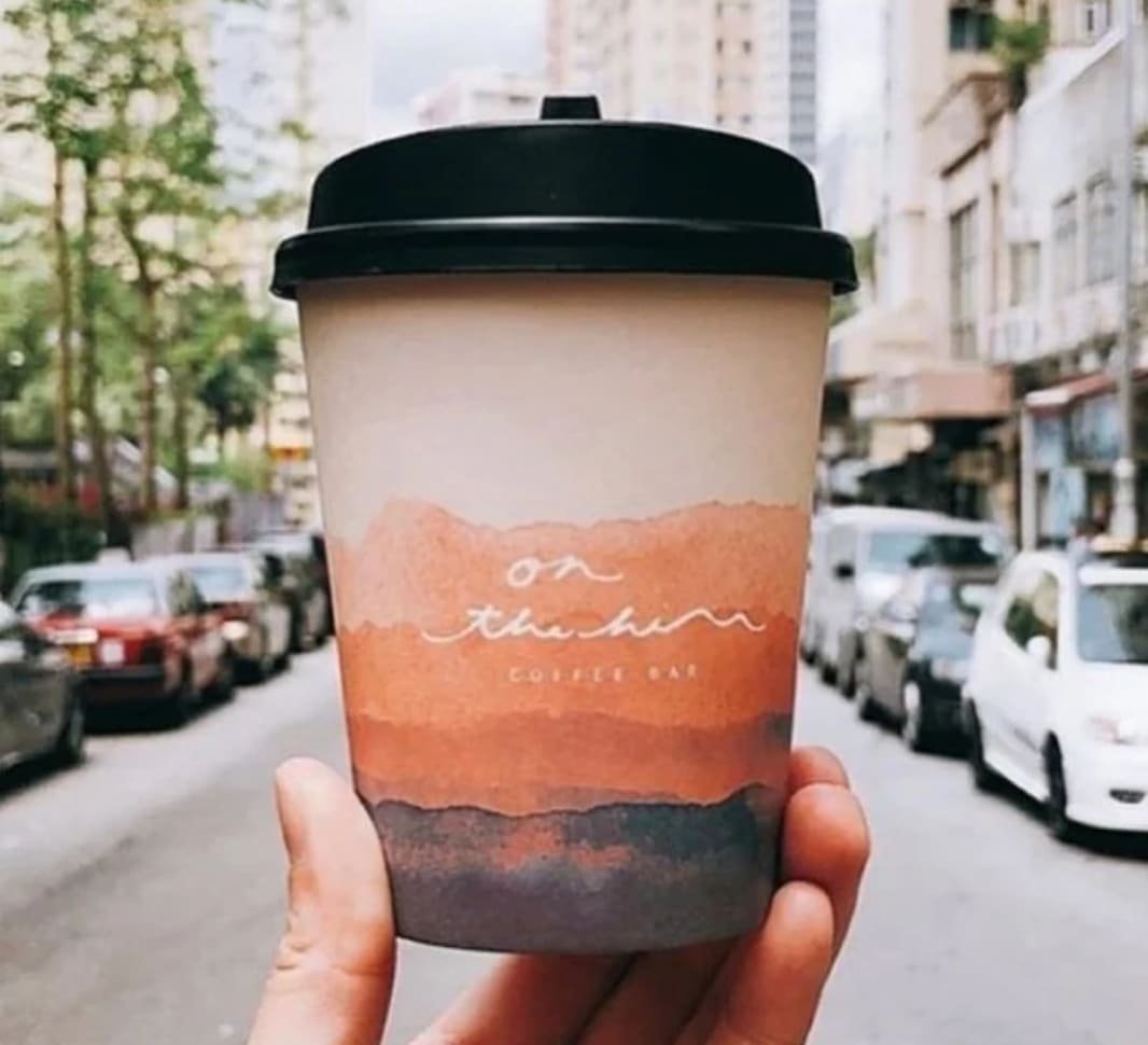 A coffee cup being held up