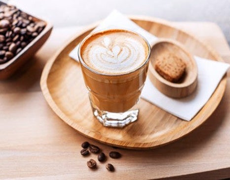 A traditional Spanish coffee in a glass on a tray