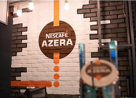 Nescafé Azera logo on a brick wall