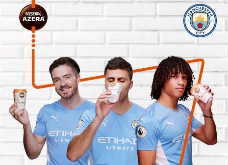 3 football players with a Nescafé Azera coffee