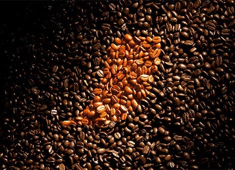 Coffee beans with the Nescafé accent on them