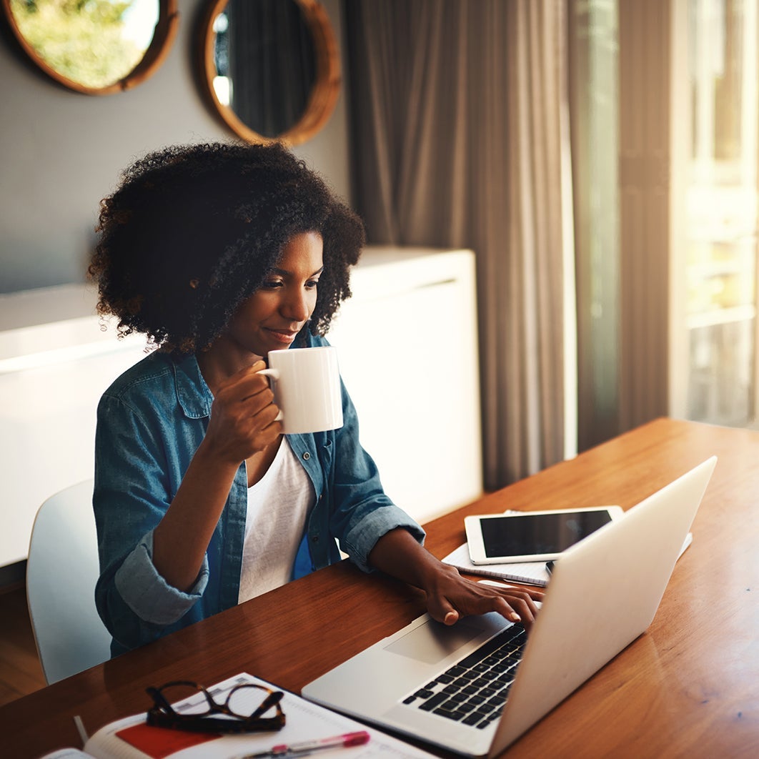 woman drinks coffee while working