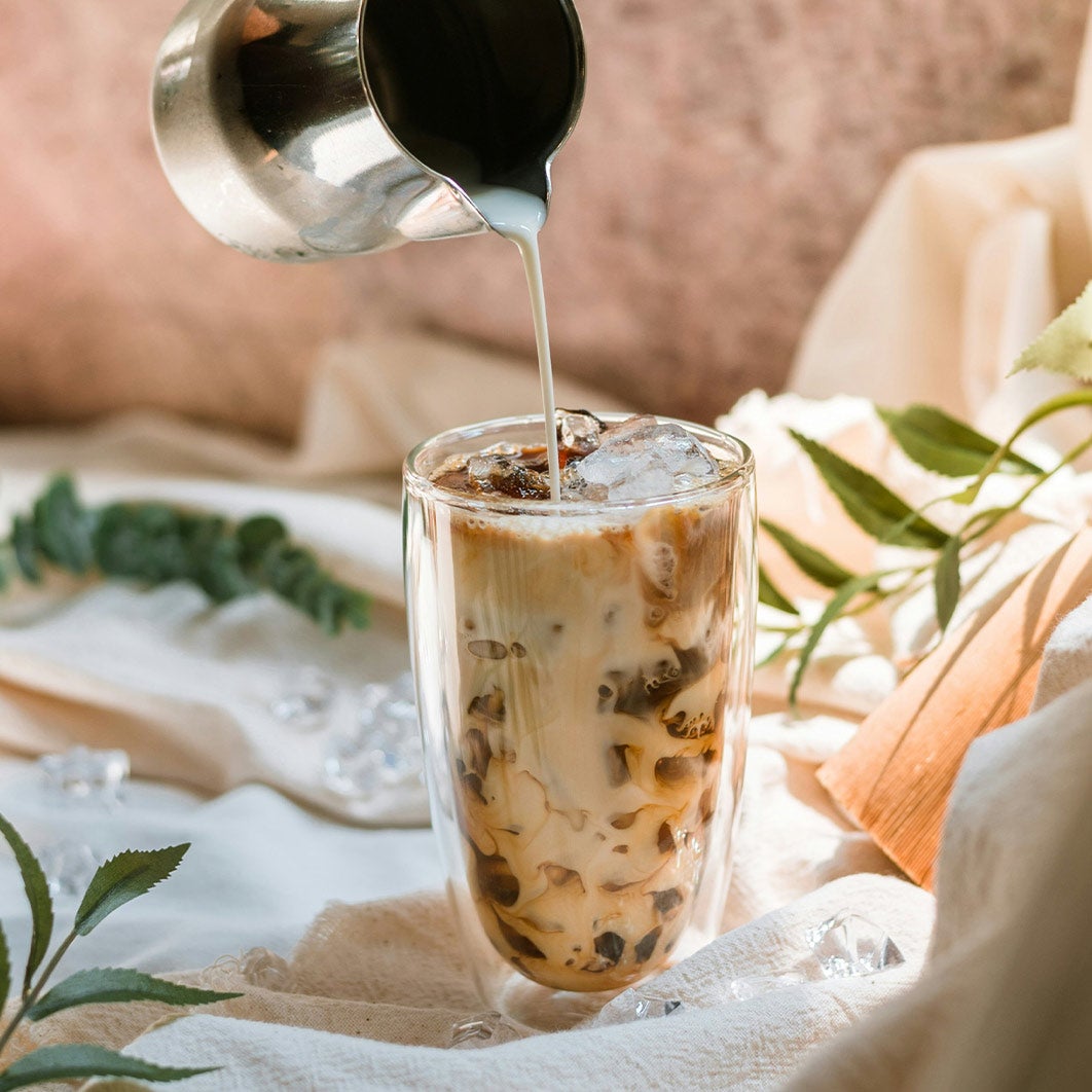 pouring milk in iced latte
