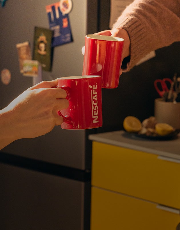 cheers with nescafe red mug