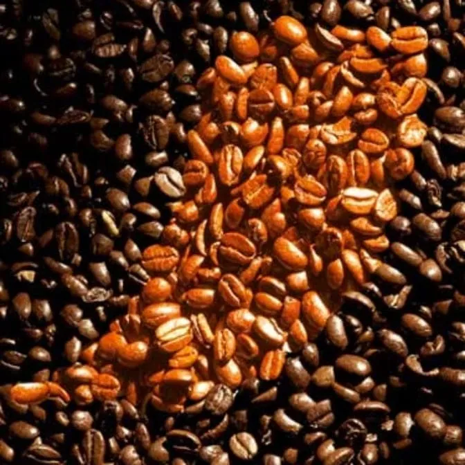 Coffee beans with the Nescafé accent on them