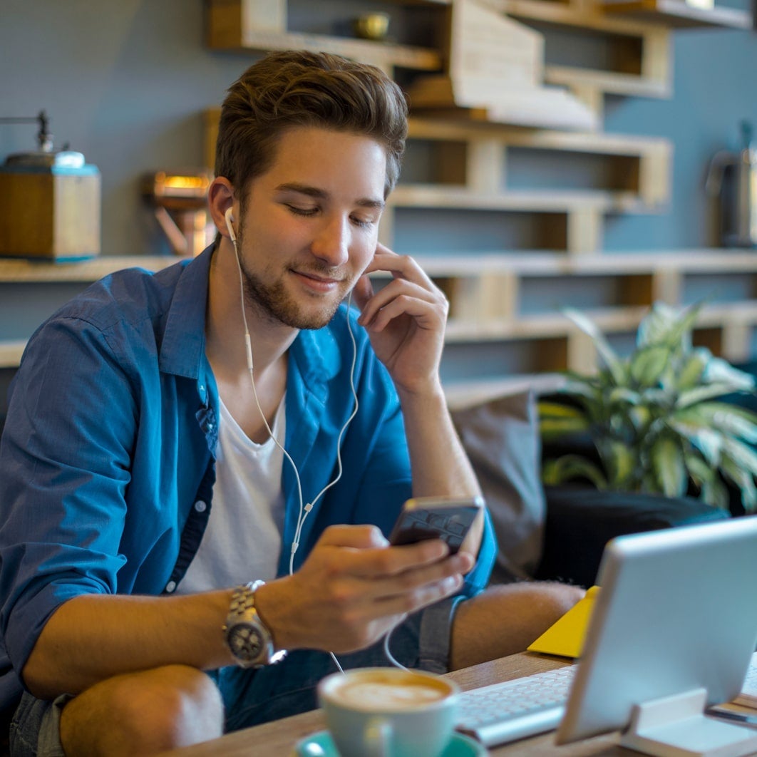 Man listening to music and drinking coffee