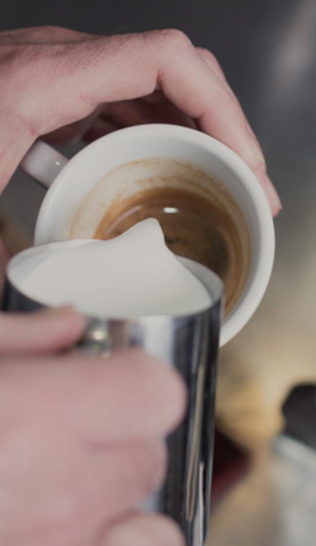 pouring milk into coffee