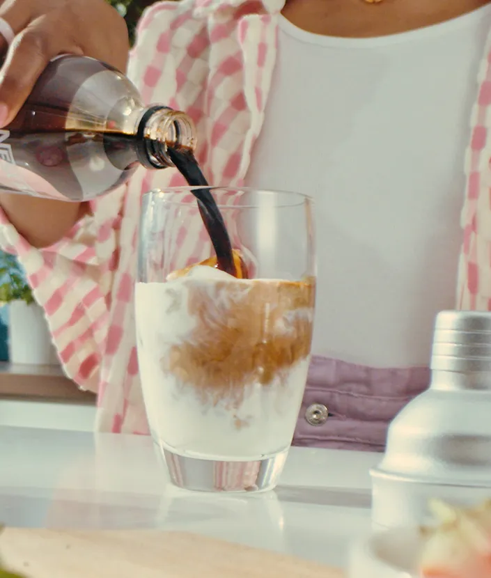 Adding NESCAFÉ Espresso Concentrate in glass