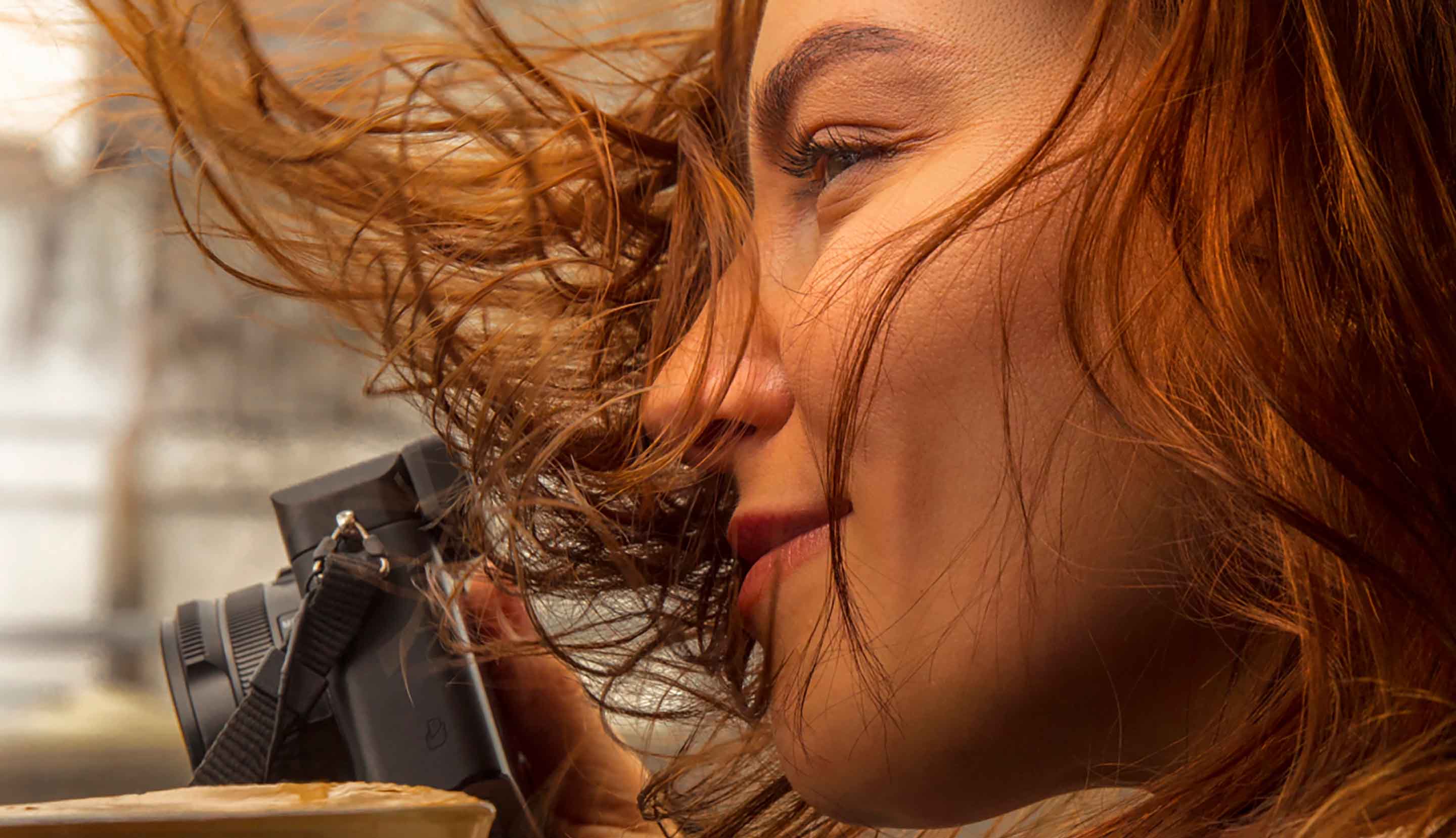 Red hair girl with camera and coffee