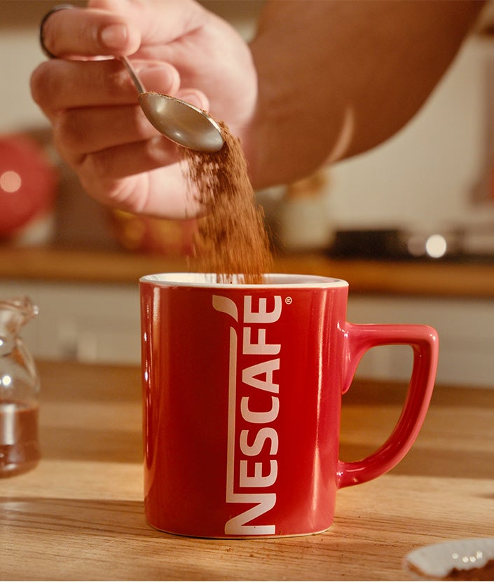 Adding coffee in the cup