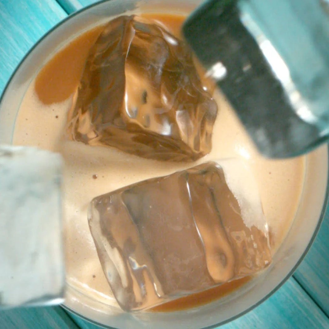 Ice cubes falling into NESCAFÉ 3in1 Ice