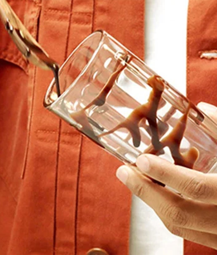 Man decorating a glass of chocolate syrup