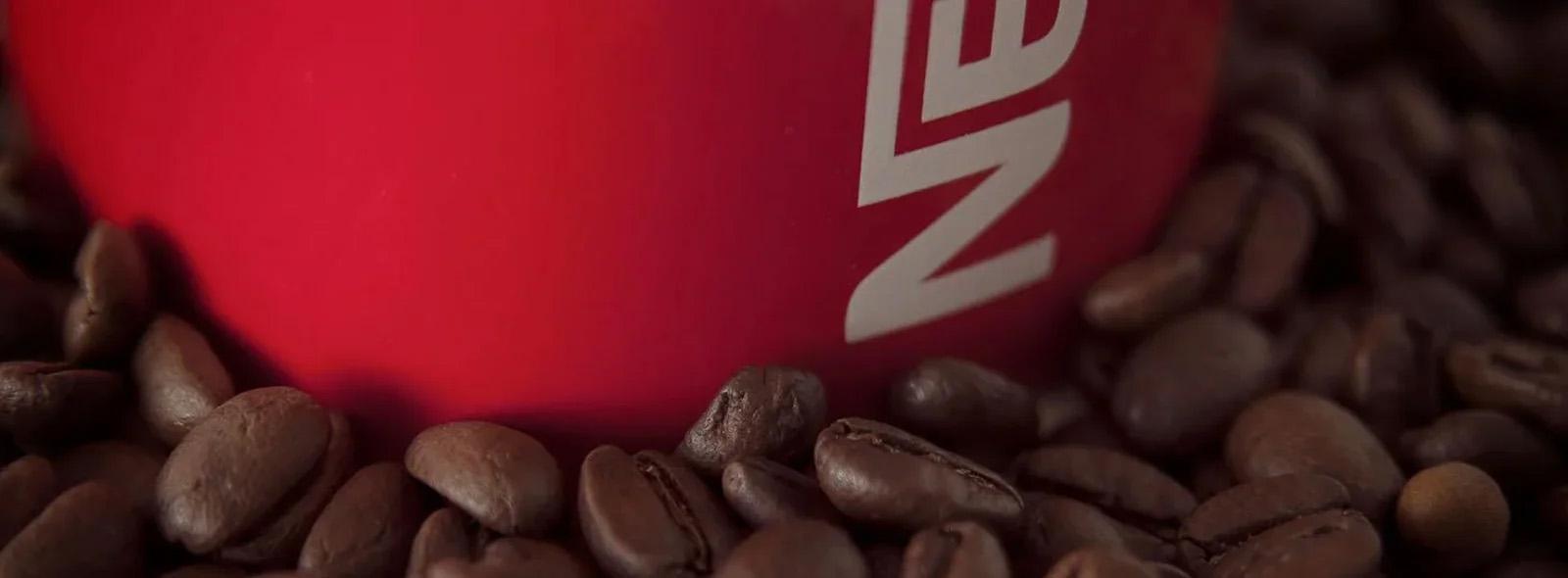 nescafe-red-mug-among-coffee-beans
