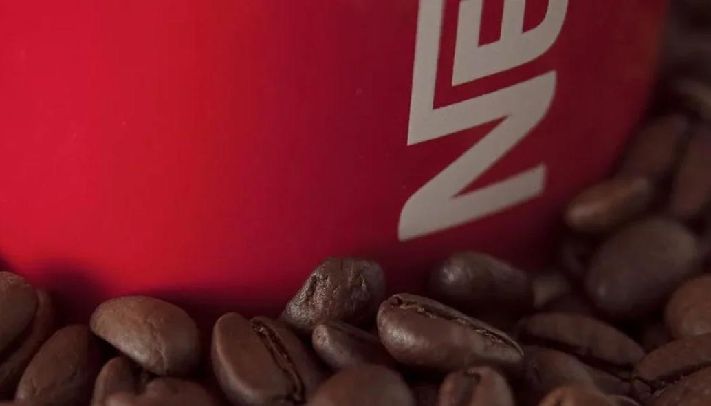 nescafe-red-mug-among-coffee-beans