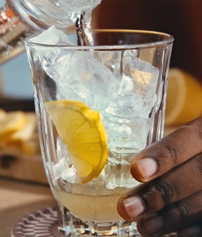 Pouring sparkling water into glass