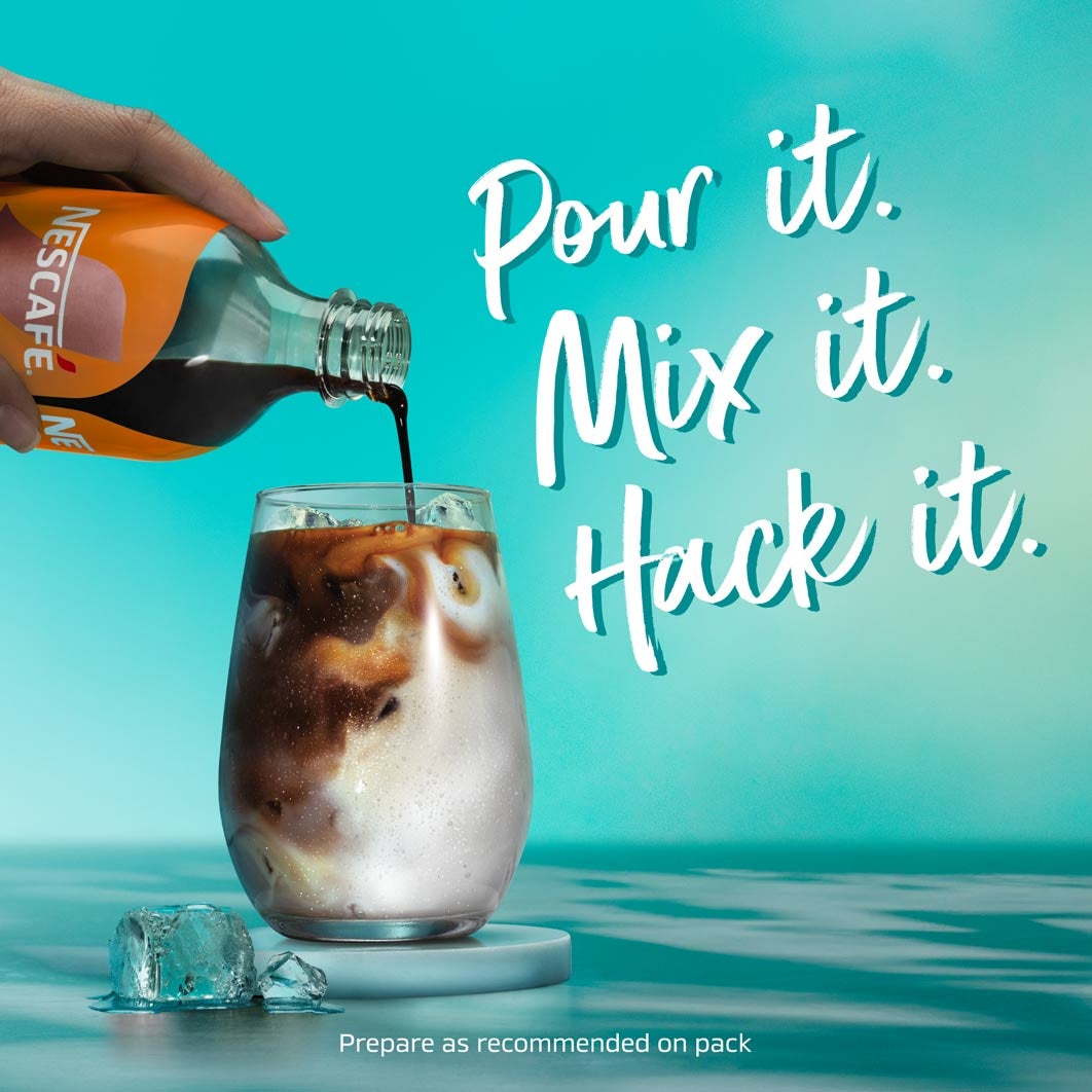 Hand pouring espresso concentrate into a glass