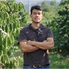 Coffee farmer standing in a coffee plantation during a sustainability interview caraousel image