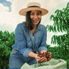 coffee farmer holding coffee cherries