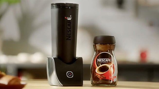 NESCAFÉ smart flask next to a jar of coffee (Not available in Europe)