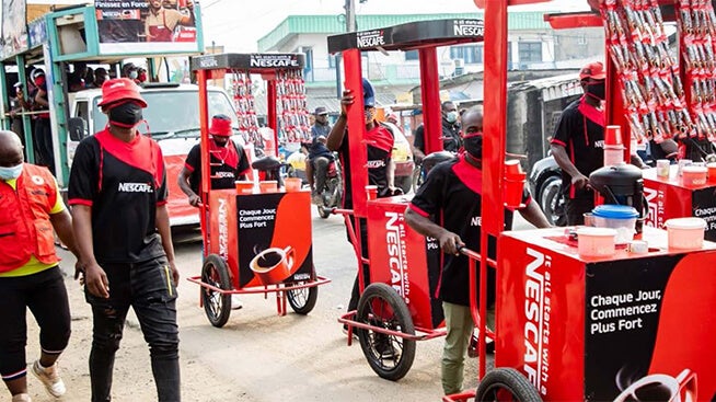 Group of people with NESCAFÉ coffee stands