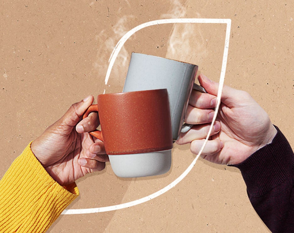Two hand holding mugs