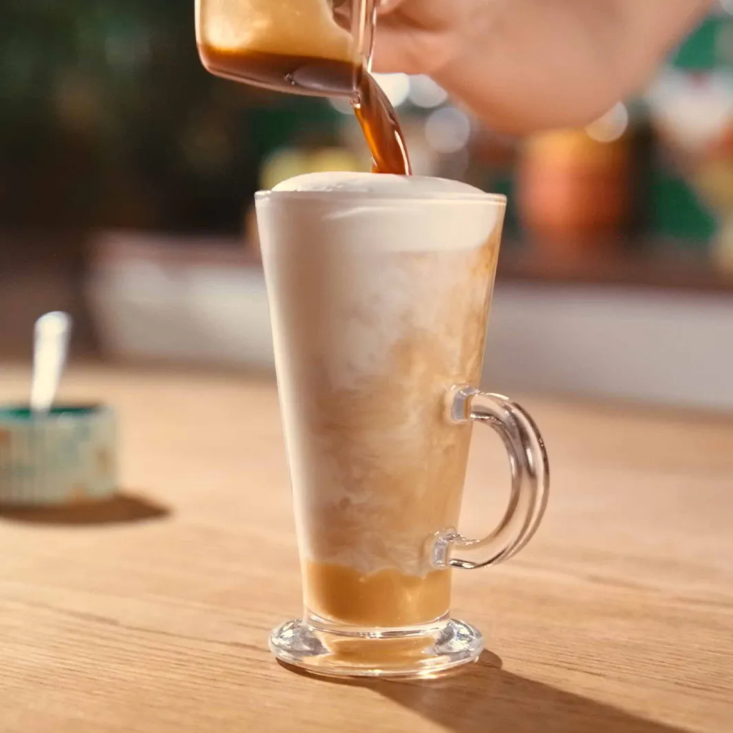 Pouring a coffee shot into a latte glass