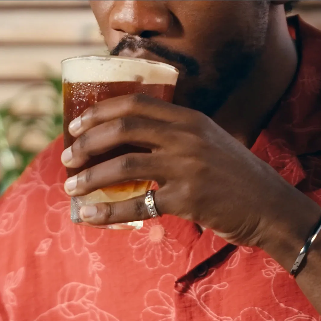 Person drinking a glass of mazagran iced coffee 