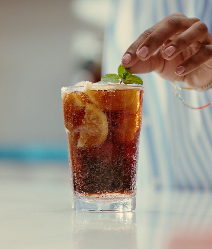 Garnishing lemonade with mint leaves