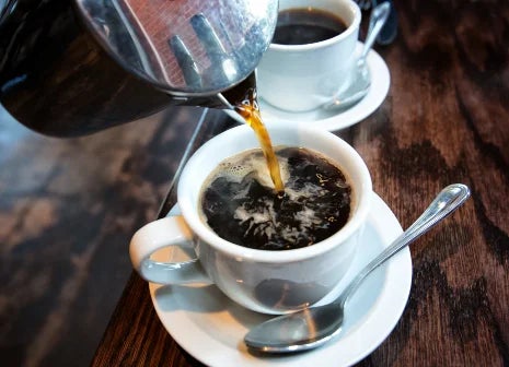 A French coffee being poured into a cup