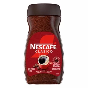 A jar of Nescafé Clásico Dark Roast with a black cap, brown label and red coffee mug.