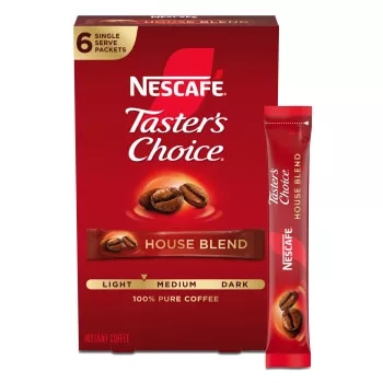 A red box of Taster’s Choice House Blend instant packets with coffee beans near the Taster's Choice logo.