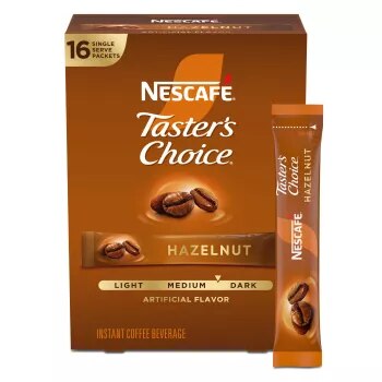 A gold box of Taster’s Choice Hazelnut instant packets coffee beans near the Taster's Choice logo.