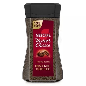 A jar of Taster’s Choice House Blend instant coffee with a black lid and coffee beans near the Taster's Choice logo.