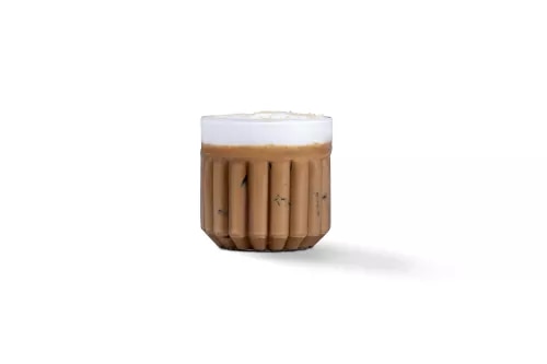 Photograph: small ribbed brown ceramic cup with white foam, shadow on white background